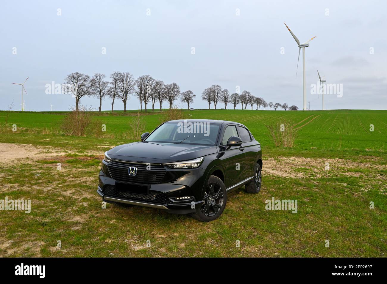 Puck, Poland - April 16, 2023: New model of black Honda HR-V hybrid parked in a field on a country road Stock Photo