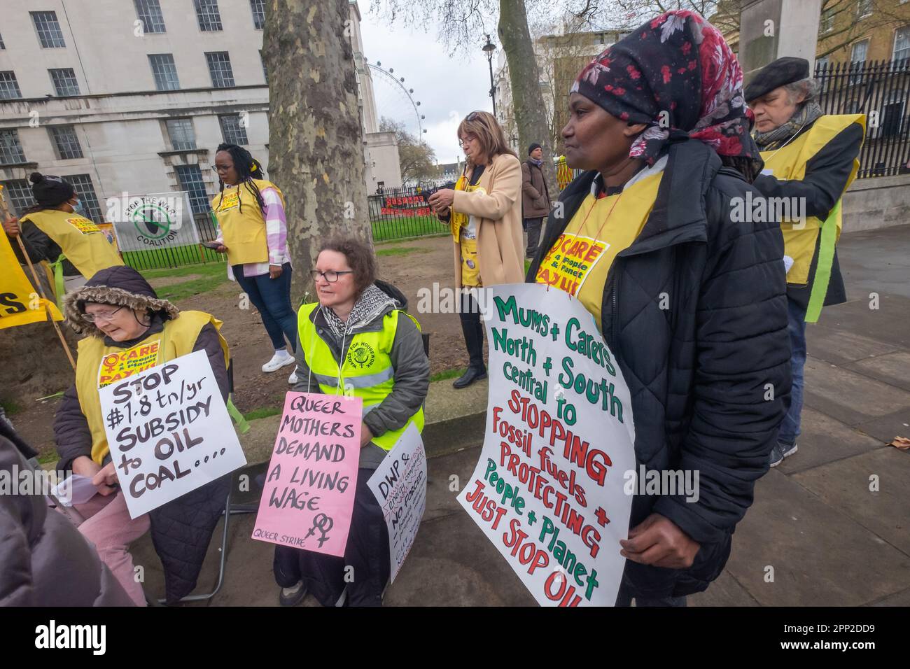 London, UK. 21 Apr 2023. On the first day of Extinction Rebellion's 'The Big One' women hold an open speakout opposite Downing St with the banner 'Care 4 People & Planet - Pay US NOT billionaire polluters''.. Women are being targeted by government cuts in mothers and disabled benefits to force them back into employment while they support fossil fuel polluters and other destructive industries. Young people and women have been at the forefront of the movement for climate justice around the world. Peter Marshall/Alamy Live News Stock Photo