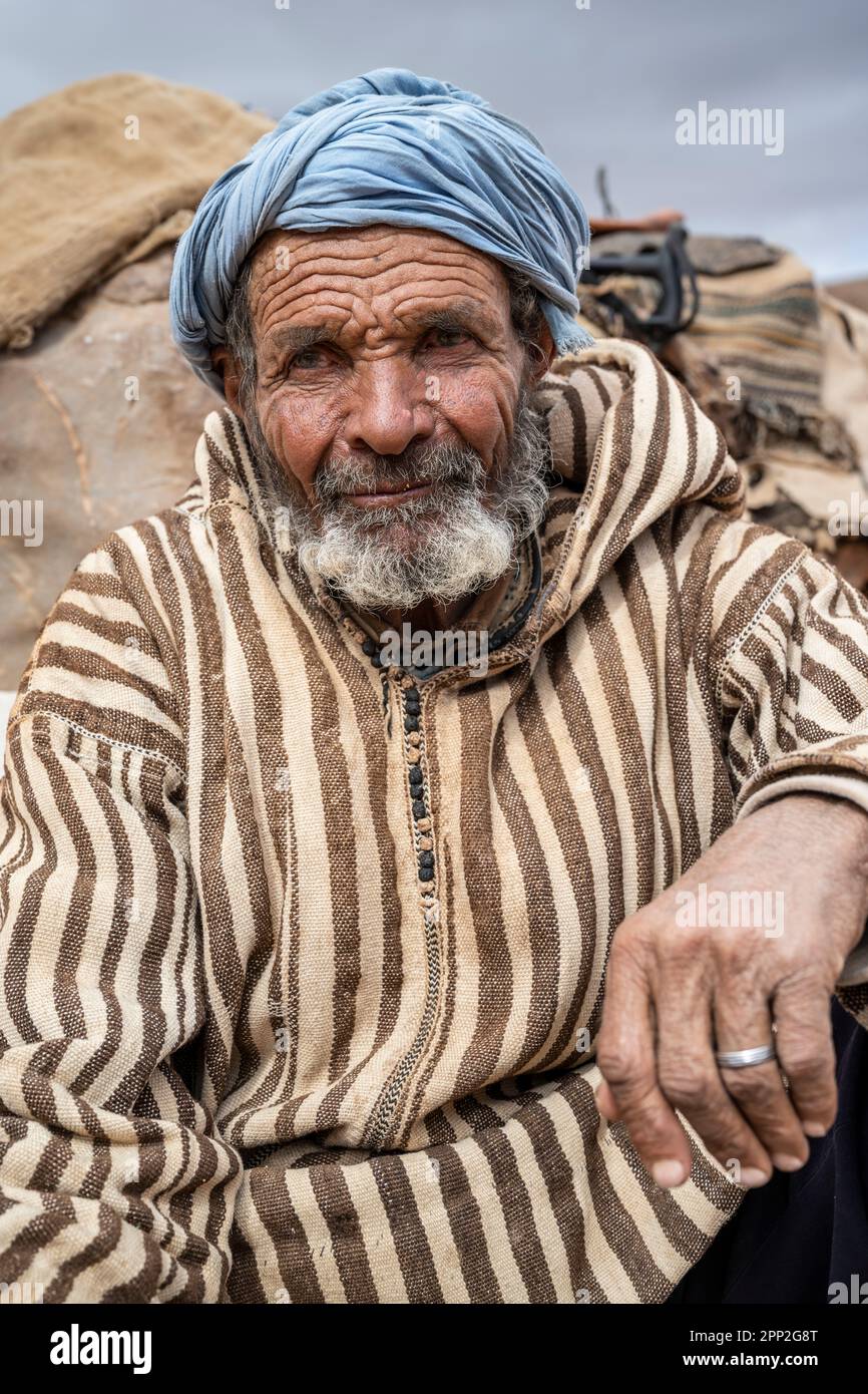Portrait of an old Berber nomad next to the cave where he lives near