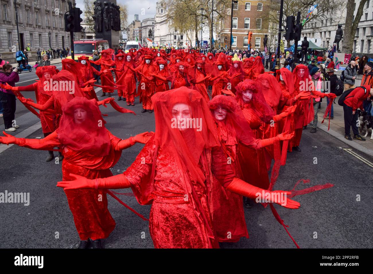 London, UK. 21st April 2023. Red Rebels pass through Whitehall as Extinction Rebellion begin their 4-day protest demanding that the government shifts away from fossil fuels and acts on the climate crisis. Credit: Vuk Valcic/Alamy Live News Stock Photo