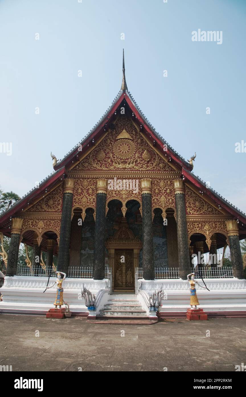 Sim or Buddhist Church of architecture in Lan Xang style, made of cement walls, with gold patterns on the gables, with murals. at Wat Mahathat. Stock Photo