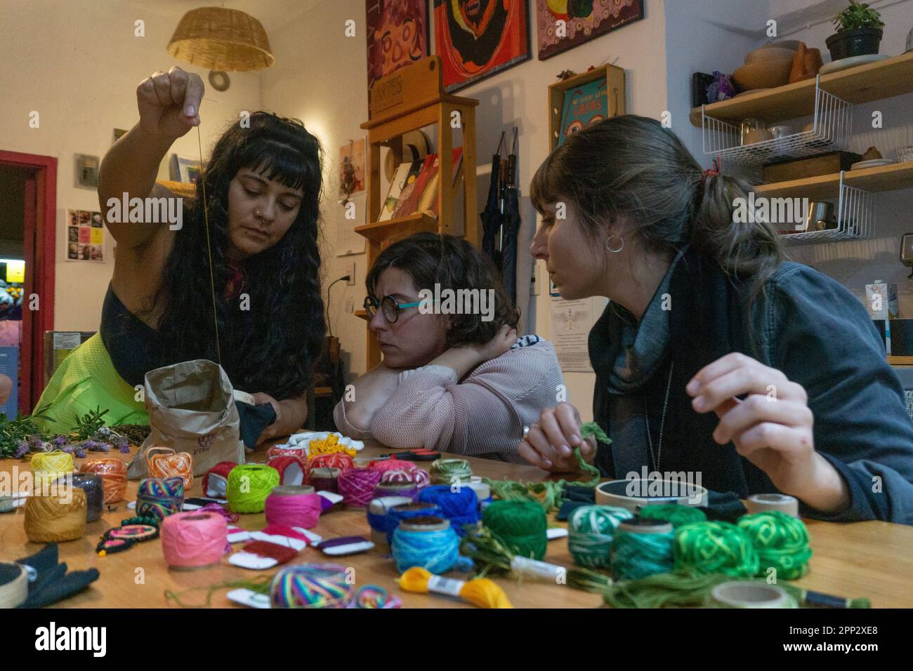 Marcela Díaz, left, teaches, from left, Josephine Donten and María Lía Idoyaga during an embroidery workshop in San Cristóbal de Las Casas, Chiapas, Mexico on Nov. 4, 2022. Díaz uses techniques she learned from Mayan women and her own knowledge to make handicrafts. (Marissa Revilla/Global Press Journal) Stock Photo