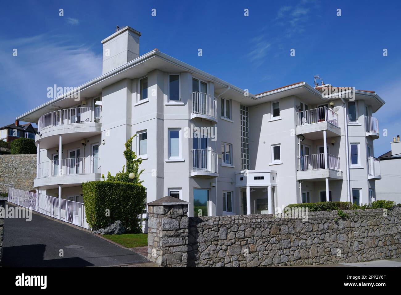 Small apartment building with white stucco exterior Stock Photo