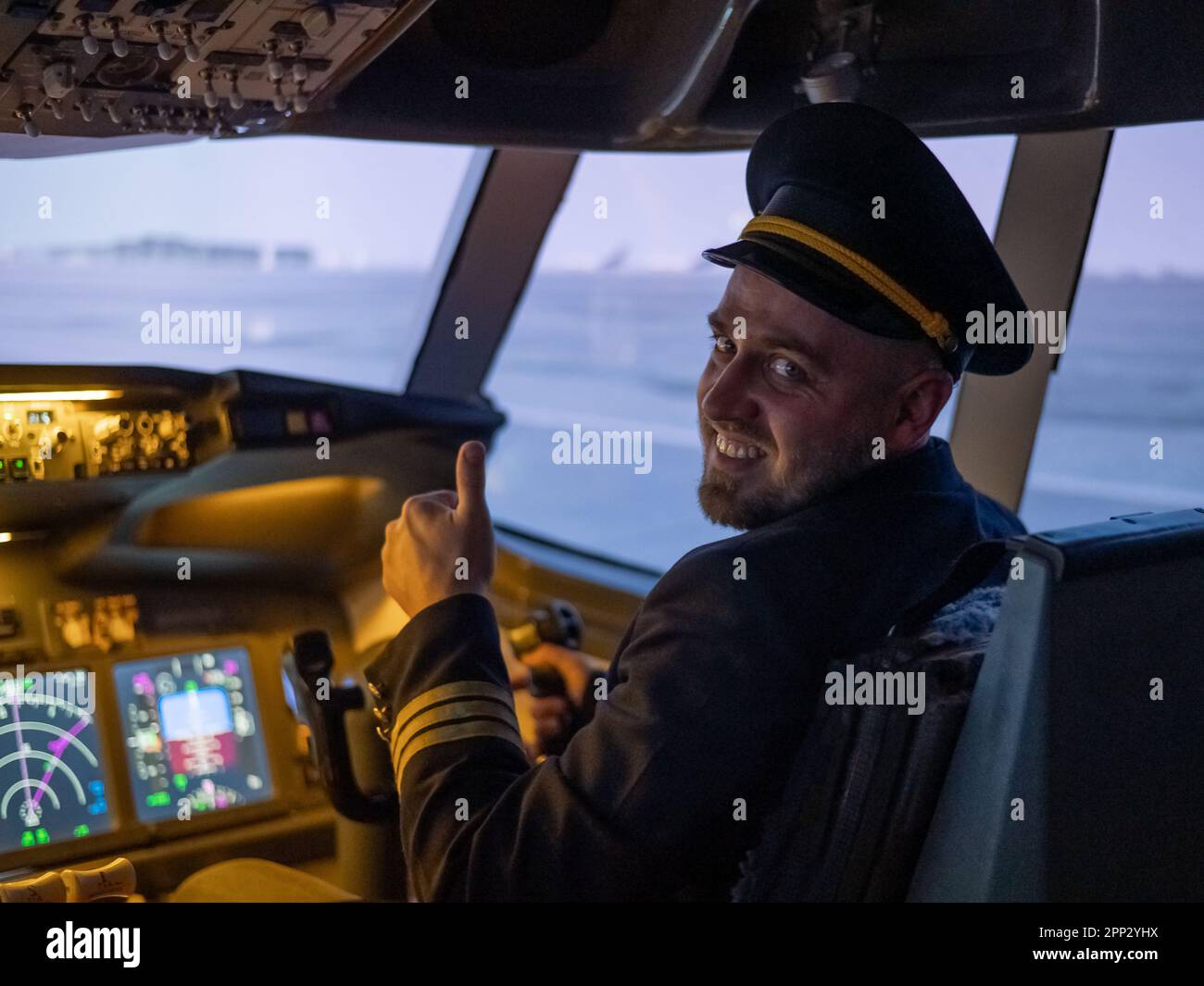 Caucasian bearded man smiling while driving a flight simulator. Pilot ...