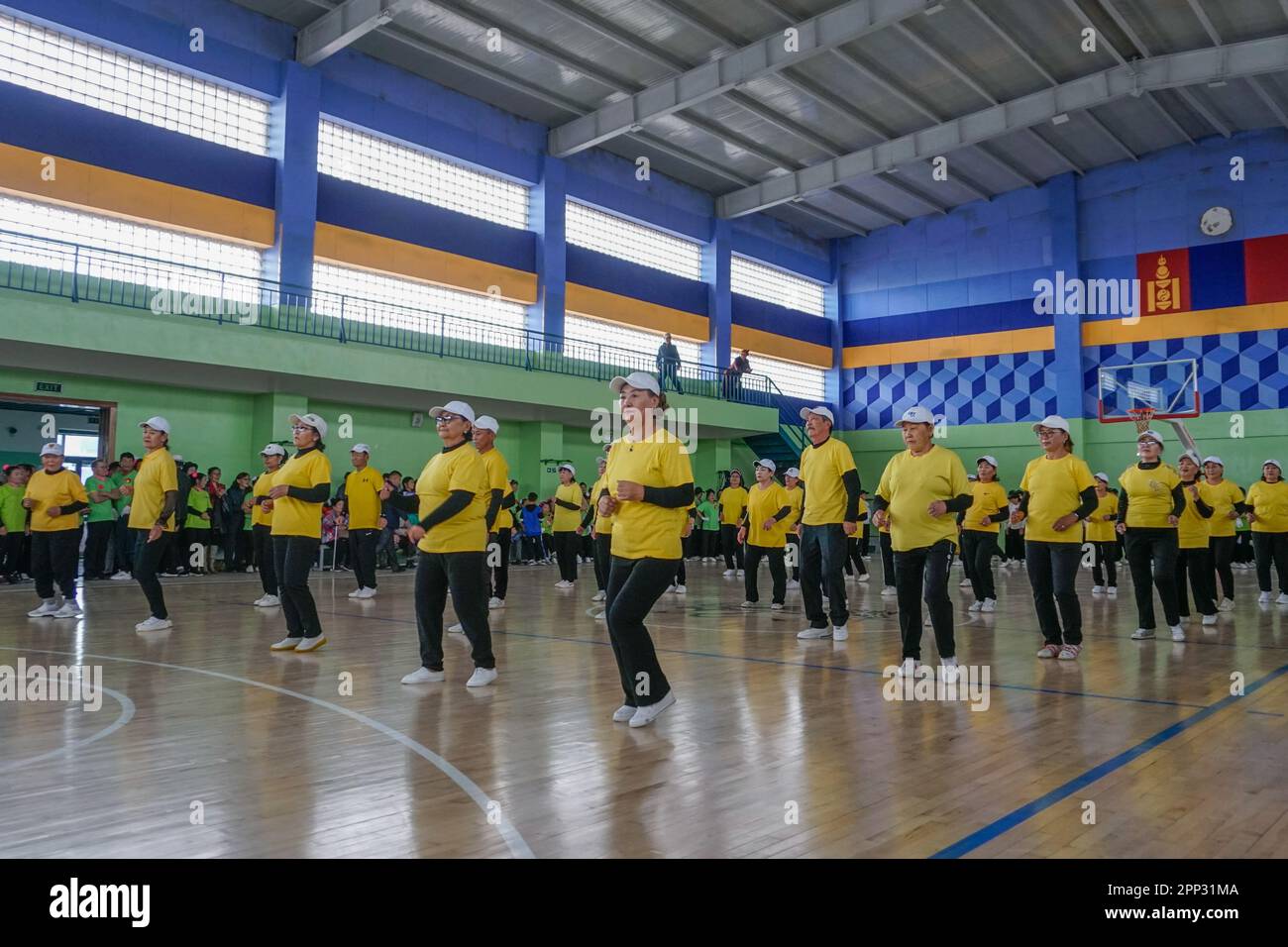 Adults dance at a gymnastics competition, which promotes physical and social activity among older adults, in Dalanzadgad, Umnugovi province, Mongolia, on Oct. 7, 2022. (Uranchimeg Tsoghuu/Global Press Journal) Stock Photo