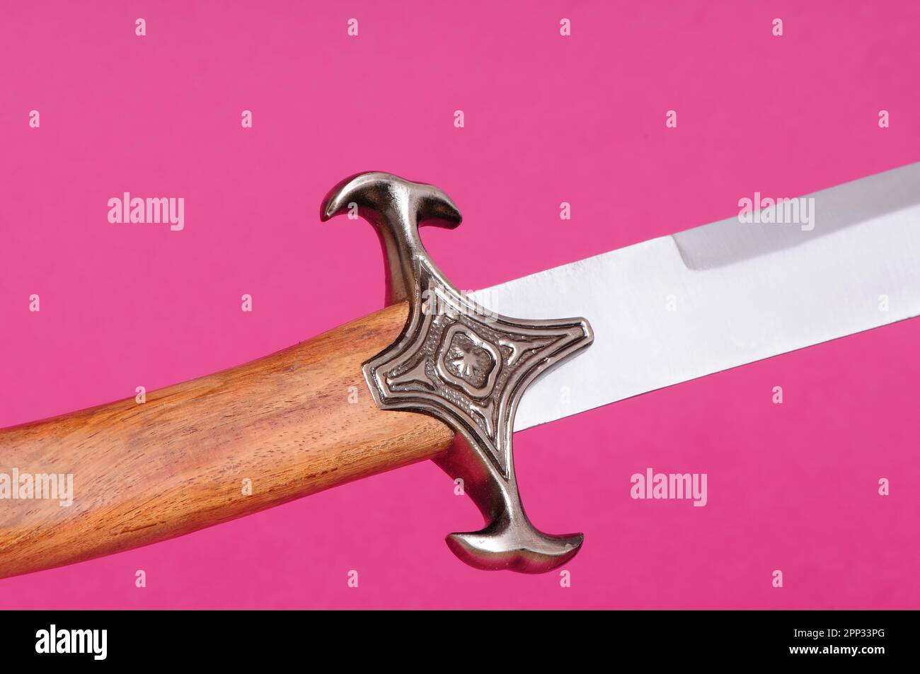 Sword hilt pommel blade and handle isolated over pink Stock Photo Alamy