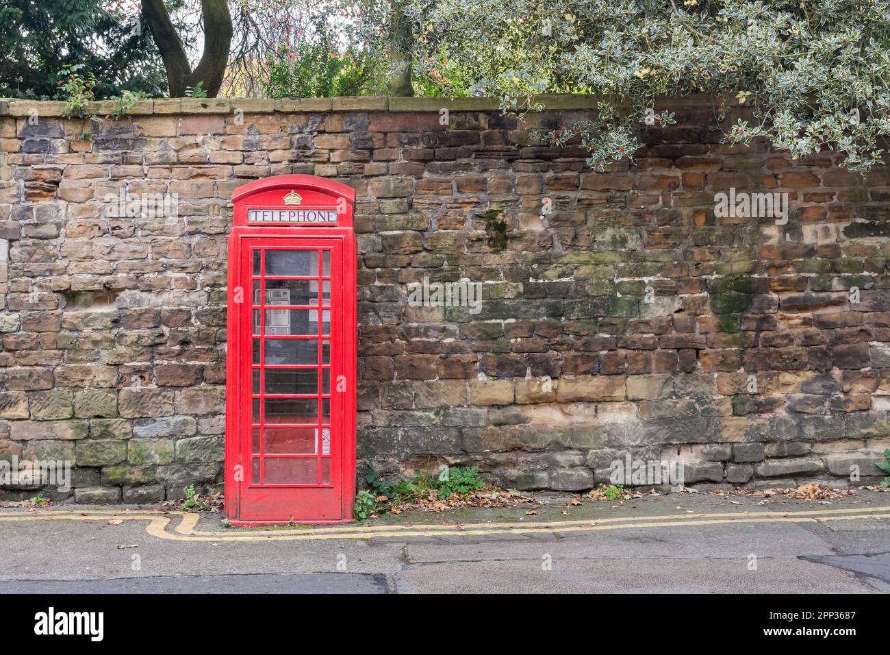 A K6 telephone kiosk, a Grade II listed historical site adjoining the castle wall at the Lenton Road entrance to The Park in Nottingham, England. Stock Photo