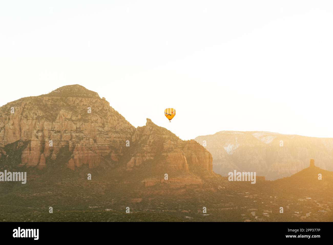 Sedona Arizona hot air balloon rises at sunrise for a group of tourists