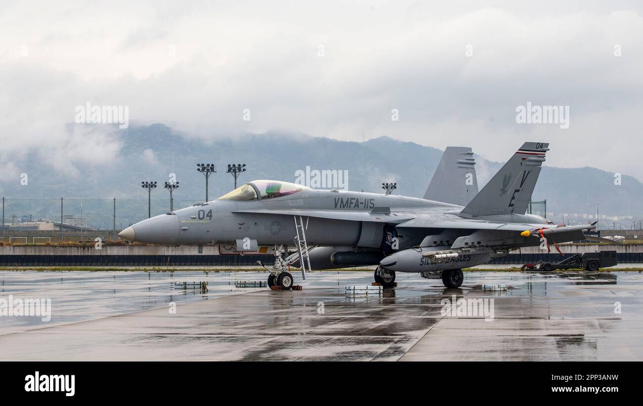 An armed U.S. Marine Corps F/A-18C Hornet aircraft with Marine Fighter Attack Squadron 115 is staged prior to launch from Marine Corps Air Station Iwakuni, Japan, April 12, 2023. Marines with Marine Aircraft Group 12 and U.S. Navy Sailors with Carrier Air Wing Five conducted a joint, live missile shoot over the Pacific to sustain their high-level of weapon proficiency, while serving as forward-postured aviation units in the Indo-Pacific region. (U.S. Marine Corps photo by Sgt. Jose Angeles) Stock Photo
