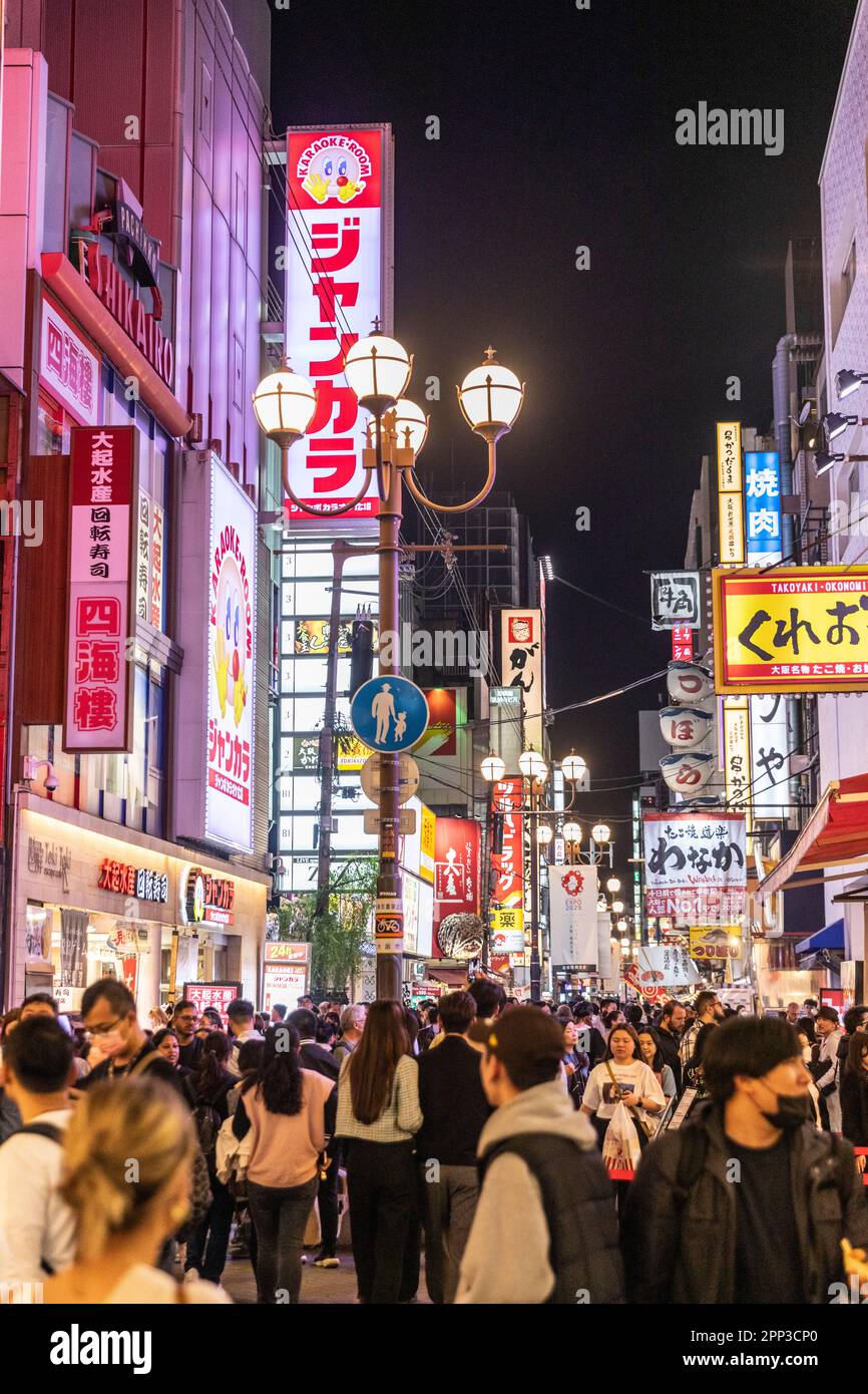 Osaka nightlife April 2023, crowds in Dotonbori district after sunset, with famous neon illuminated streets of Osaka, Japan, spring evening,Asia Stock Photo
