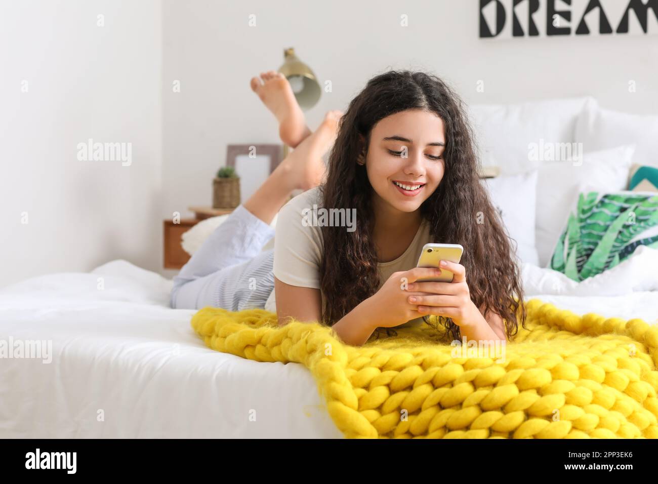 Teenage girl using mobile phone in bedroom Stock Photo - Alamy
