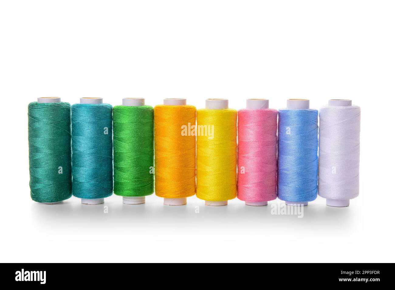 Set of colorful thread spools on white background Stock Photo - Alamy