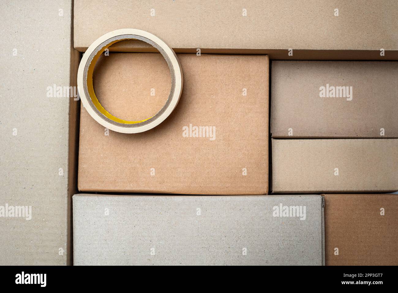 Sticky tape on a lot of cardboard boxes background. Moving, delivery