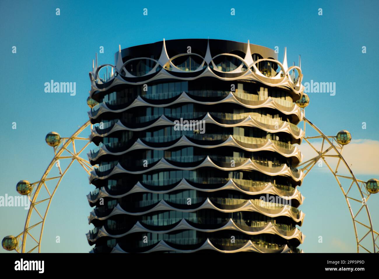 Melbourne Star Observation Deck Wheel in Morning Sun behind high rise