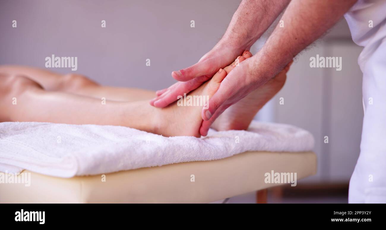 Reflexology Foot Massage Treatment. Woman Wellness Therapy Stock Photo