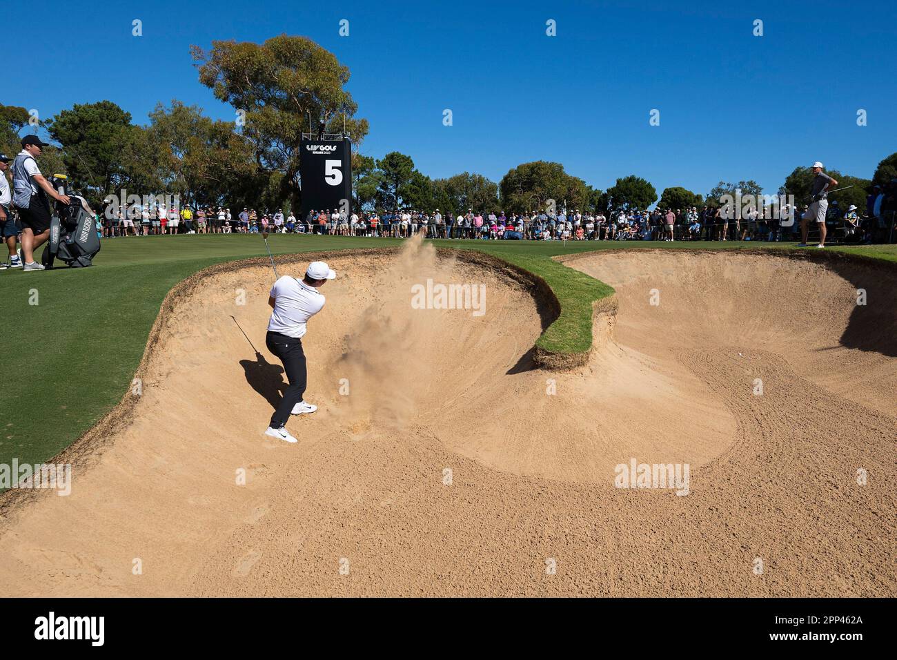 Danny Lee of Iron Heads GC hits his shot from a bunker on the fifth
