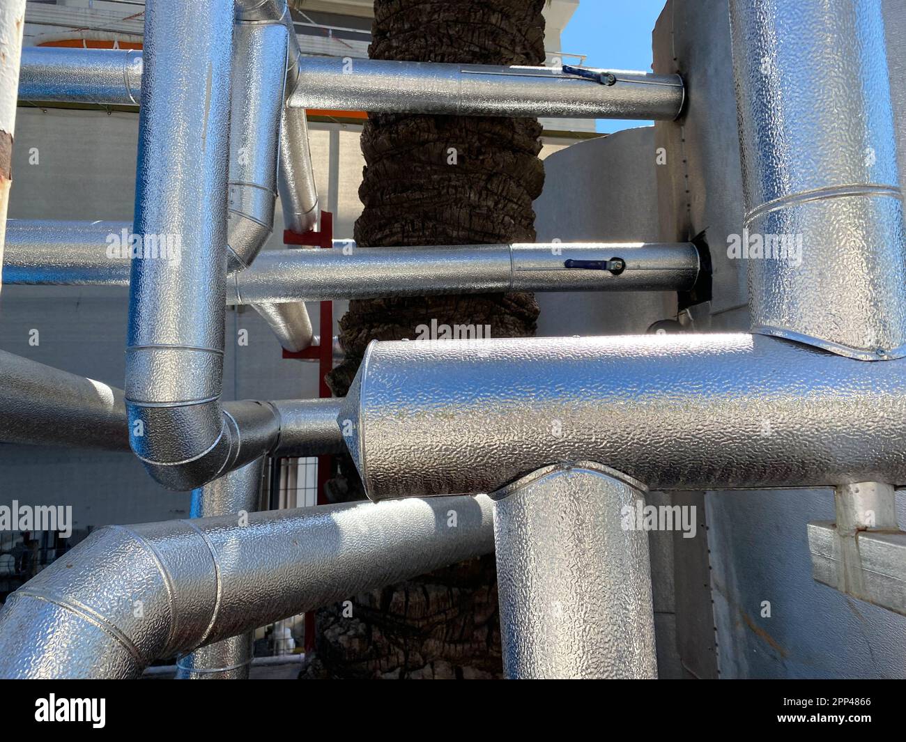 Ventilation pipes in silver insulation material hanging from the