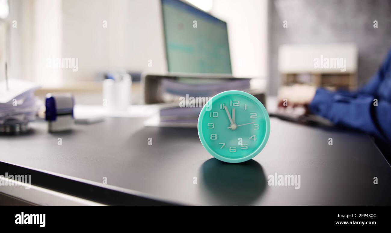 Accountant Calculating Bill With Time Clock. Money Alarm Stock Photo