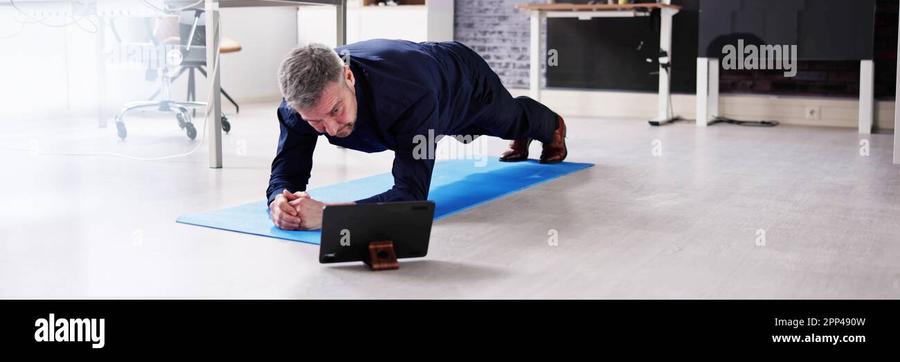 Man Doing Office Plank Exercise Workout Training Stock Photo