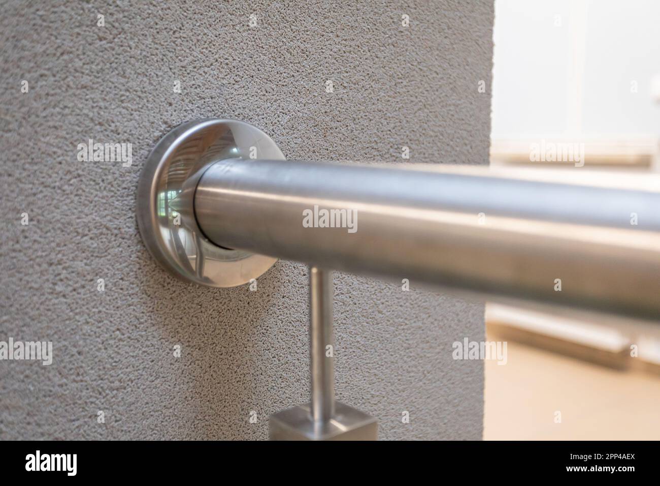 Attached round stainless steel railing bracket to the wall Stock Photo ...