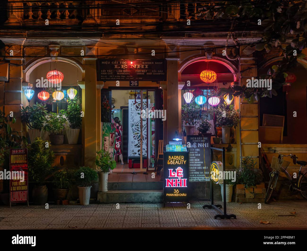 Beauty salon in Hoi An, Quang Nam province, Vietnam at night. The old city of Hoi An is a World Heritage Site, and famous for its well preserved build Stock Photo