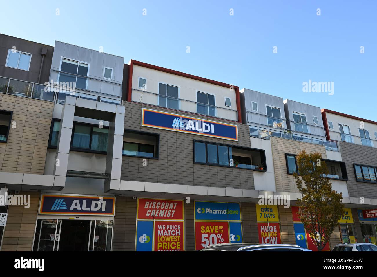 Modern building on Centre Rd featuring an Aldi supermarket and Pharmasave discount chemist alongside apartments Stock Photo