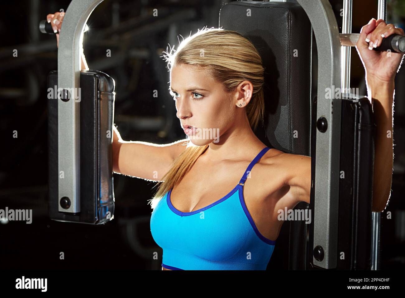 Getting a great upper body workout. a young woman using an exercise