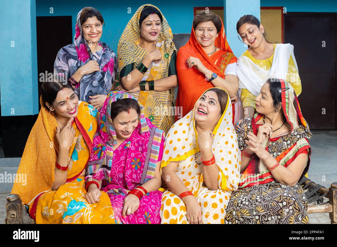 Group of happy young traditional indian women friends wearing colorful