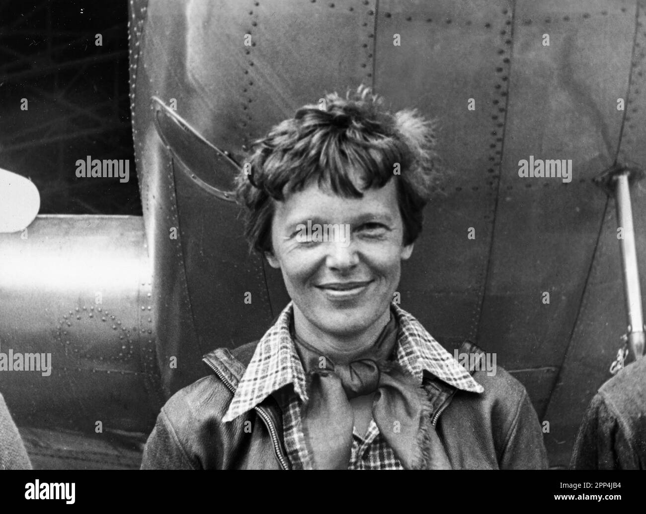 Amelia Earhart standing under nose of her Lockheed Model 10-E Electra. Gelatin silver print, 1937. Photograph by Underwood & Underwood. Location: Cali Stock Photo
