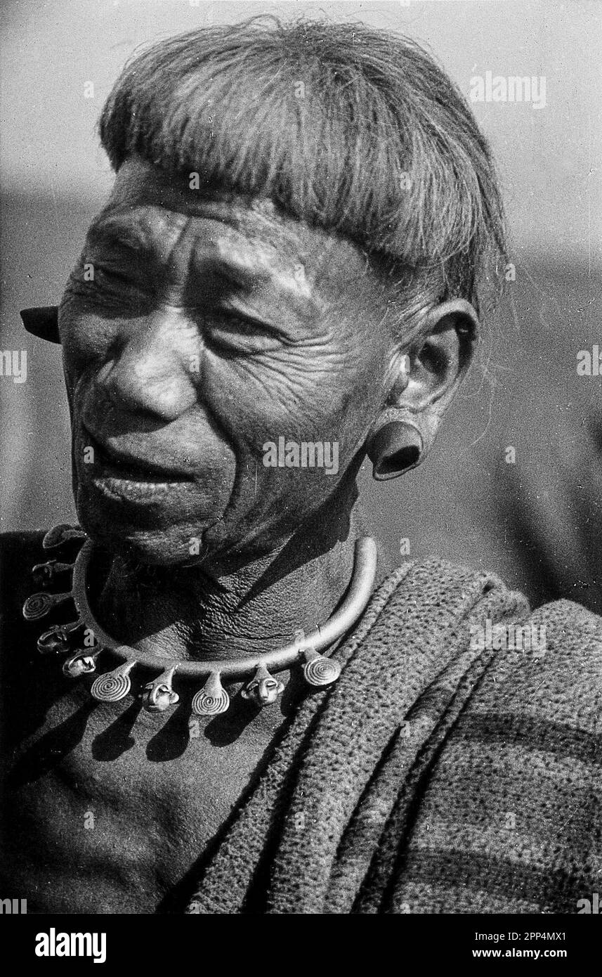 A man of the Konyak Naga tribe, with plugs distorting his ears and a necklace indicating the number of heads he has cut off. Stock Photo