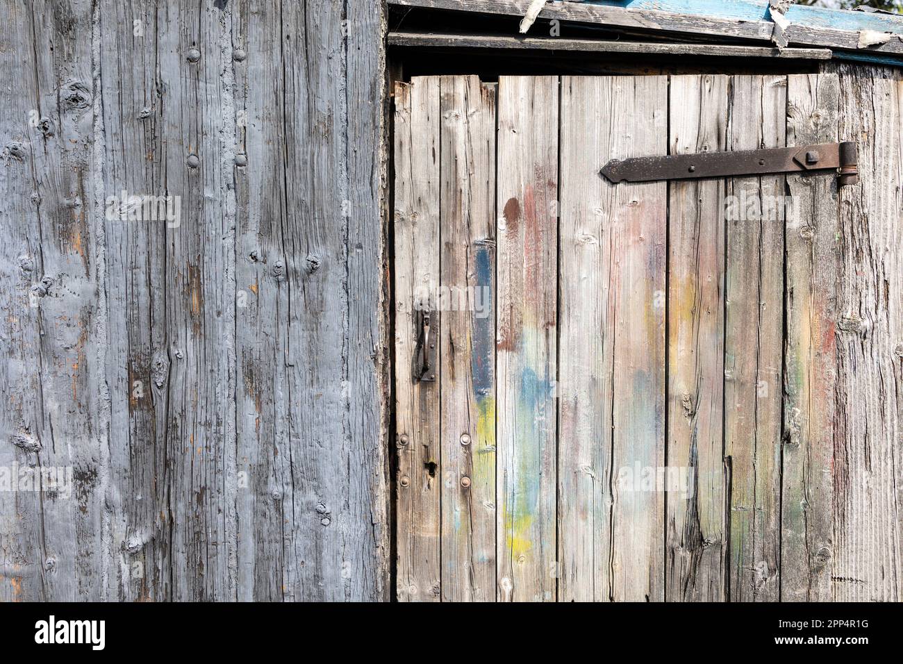 rusty old metal door hinge. Wooden barn door textured background with