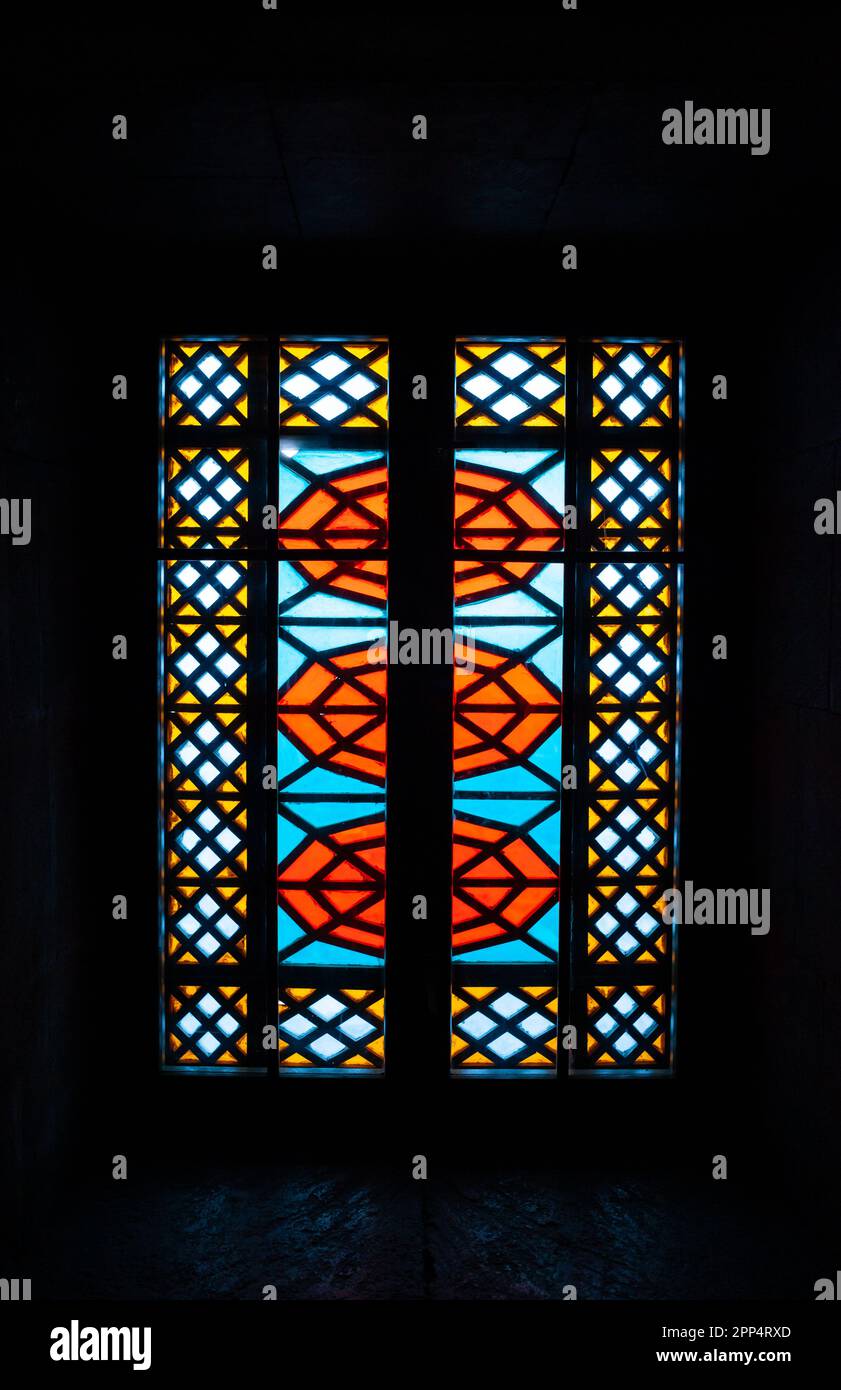 Window Simetric Image An old window with mosaics, multicolored glasses of red, blue, yellow ...