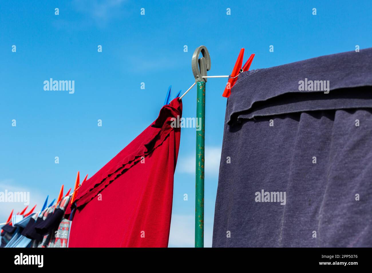 Clothes drying on a washing line with blue sky Stock Photo