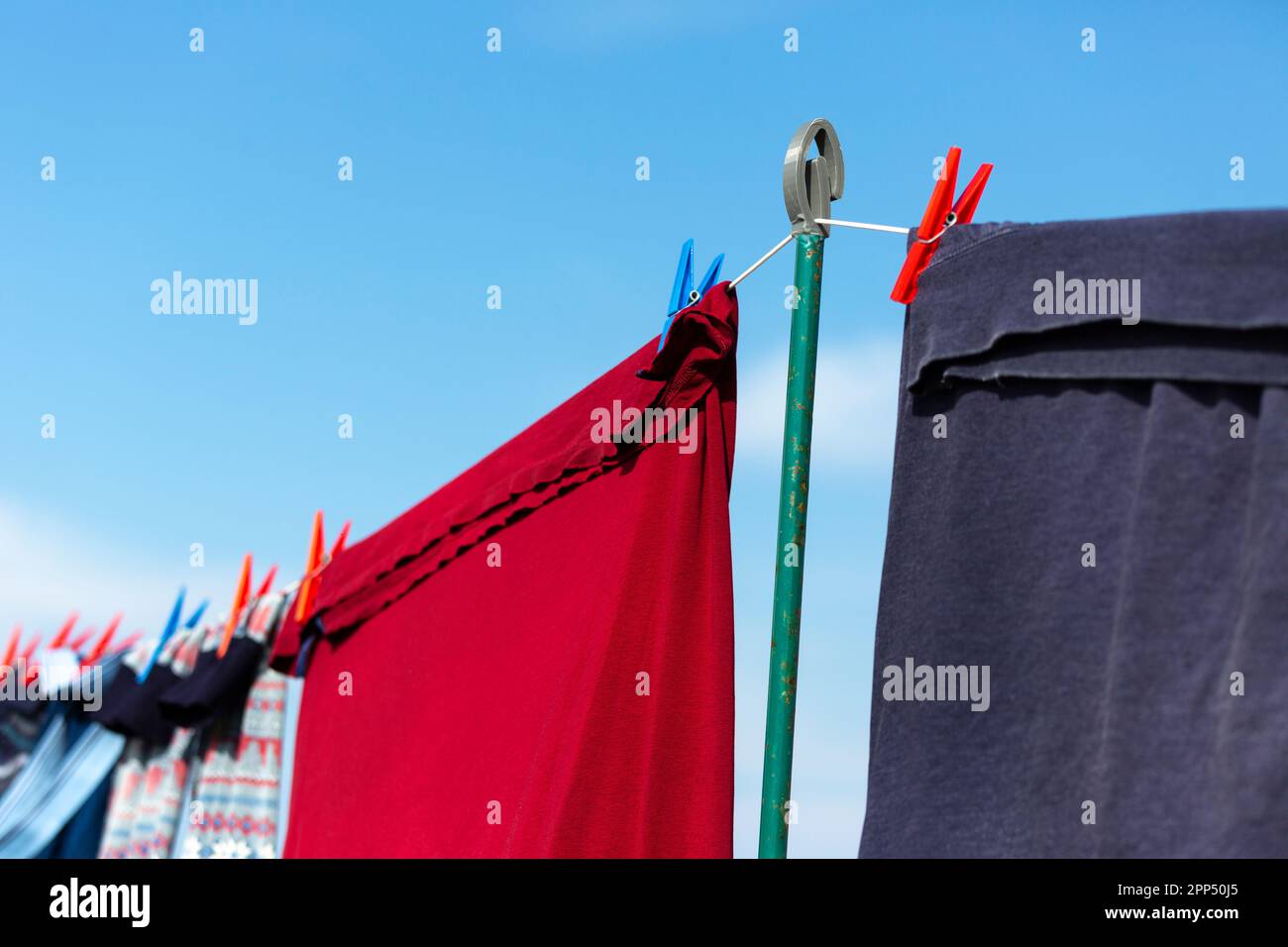 Clothes drying on a washing line with blue sky Stock Photo