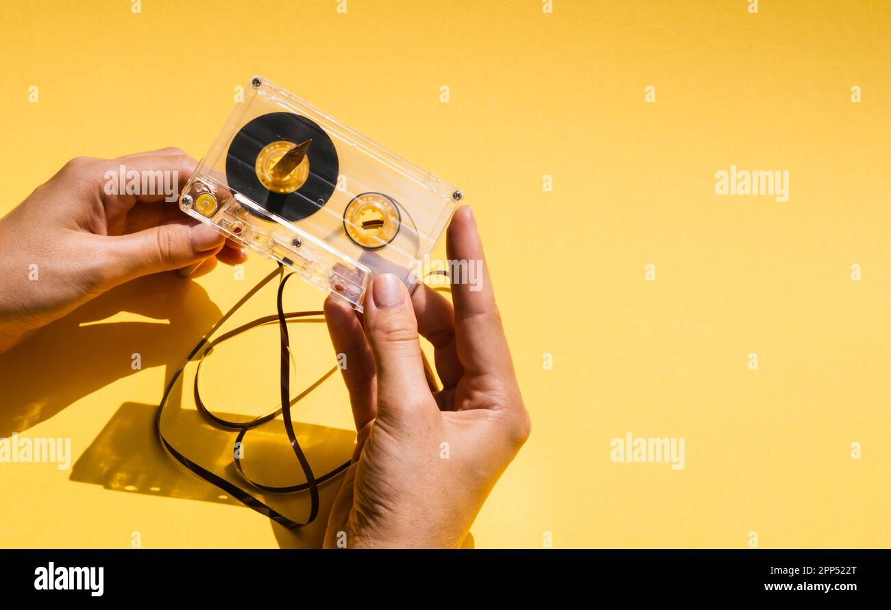 Person holding broken cassette tape with copy space Stock Photo