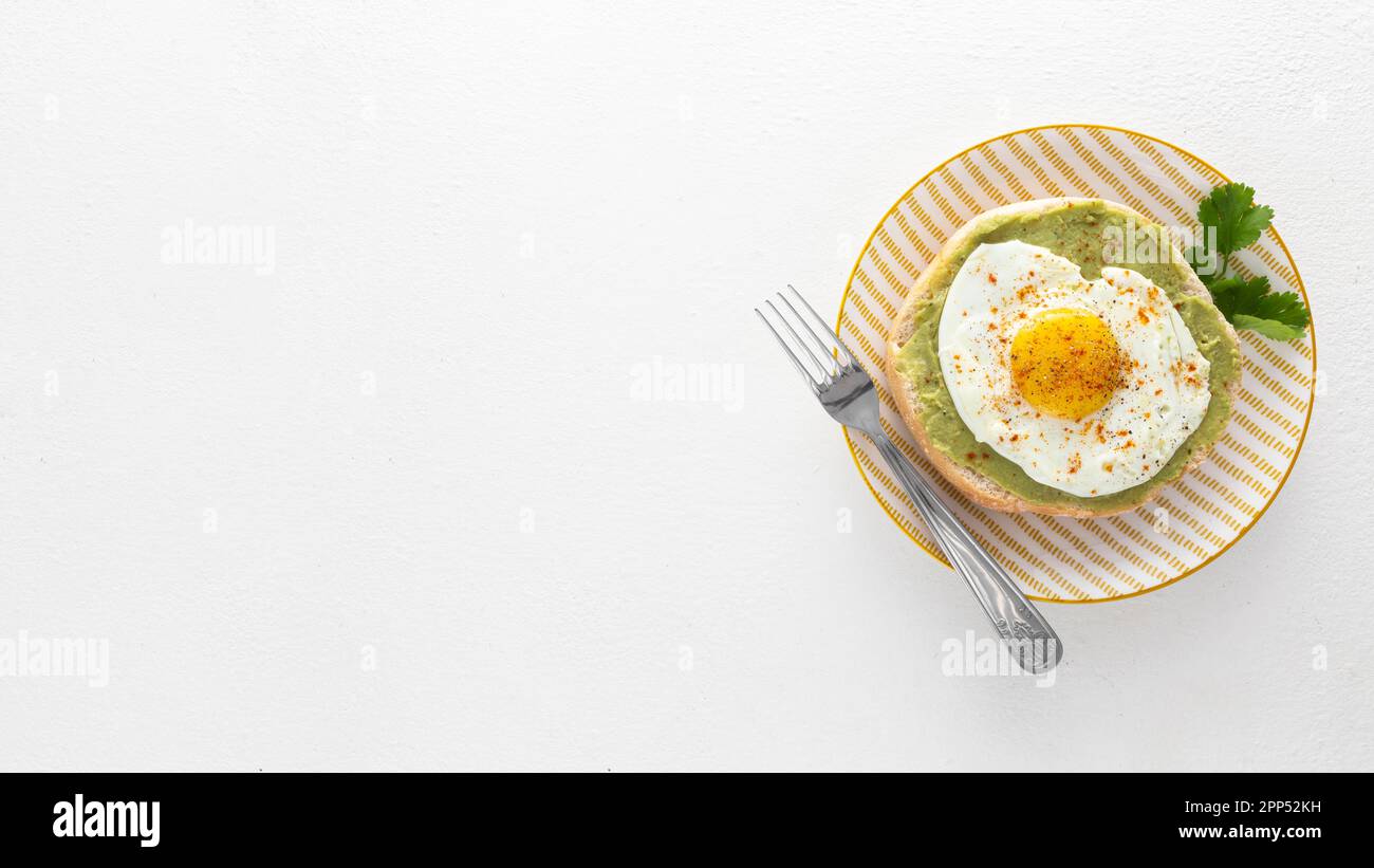 Flat lay pita with avocado fried egg plate with copy space Stock Photo