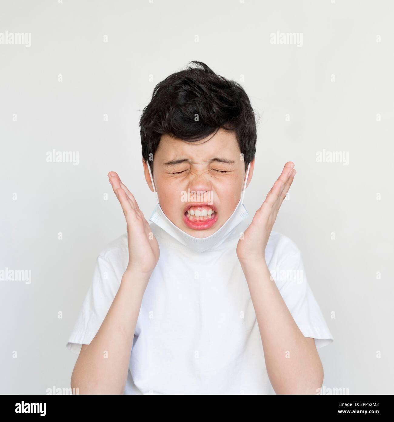 Front view young boy sneezing Stock Photo