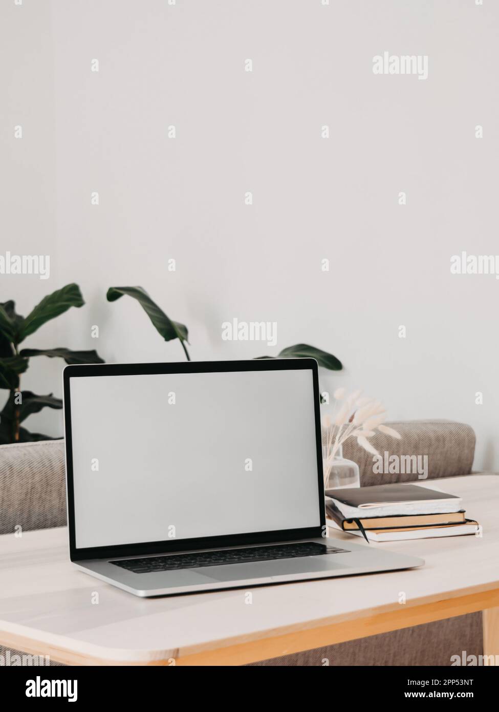 Laptop with blank screen on wooden table in home interior. Workplace ...