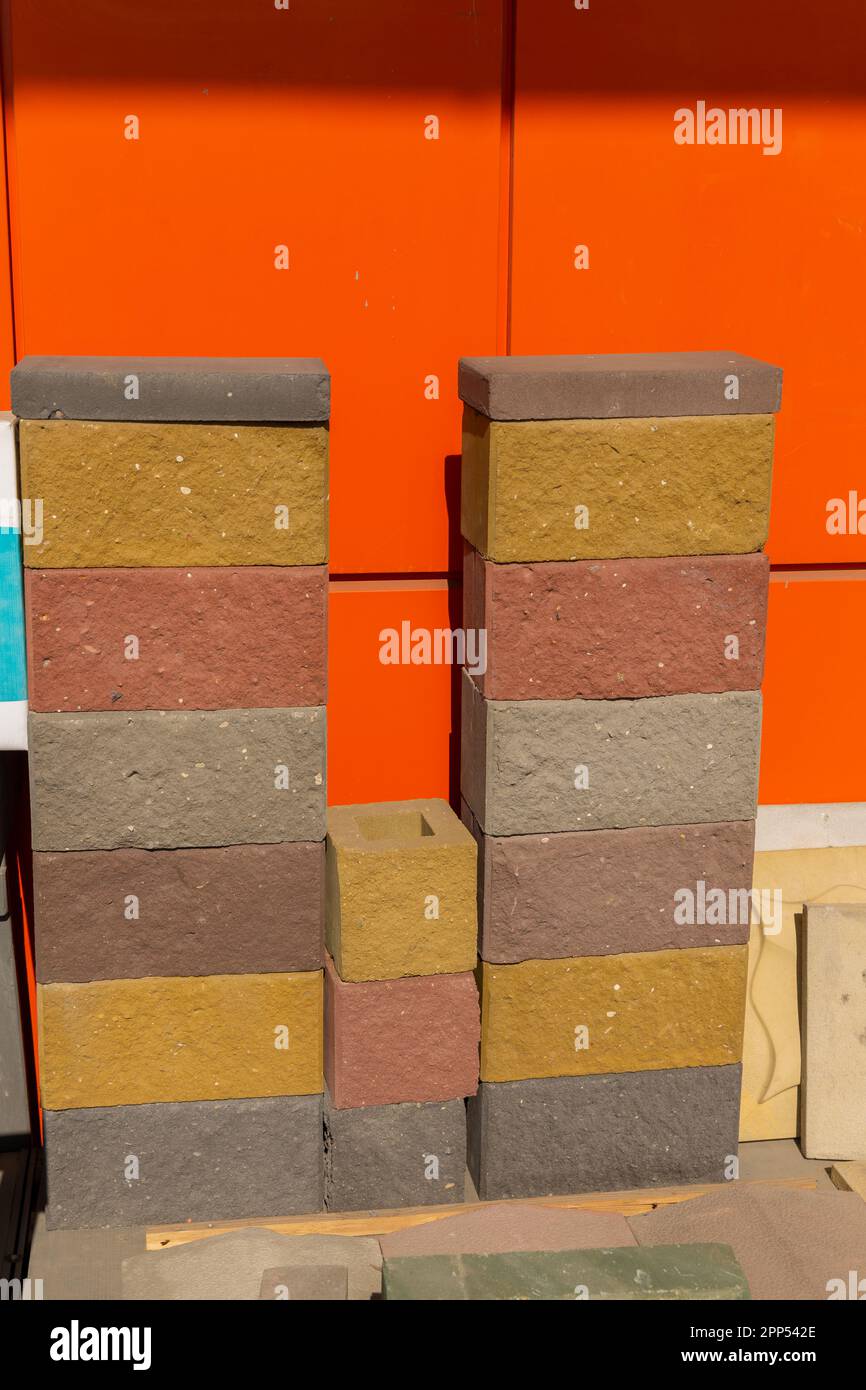 Samples of multicolored building blocks made of pressed cementsand