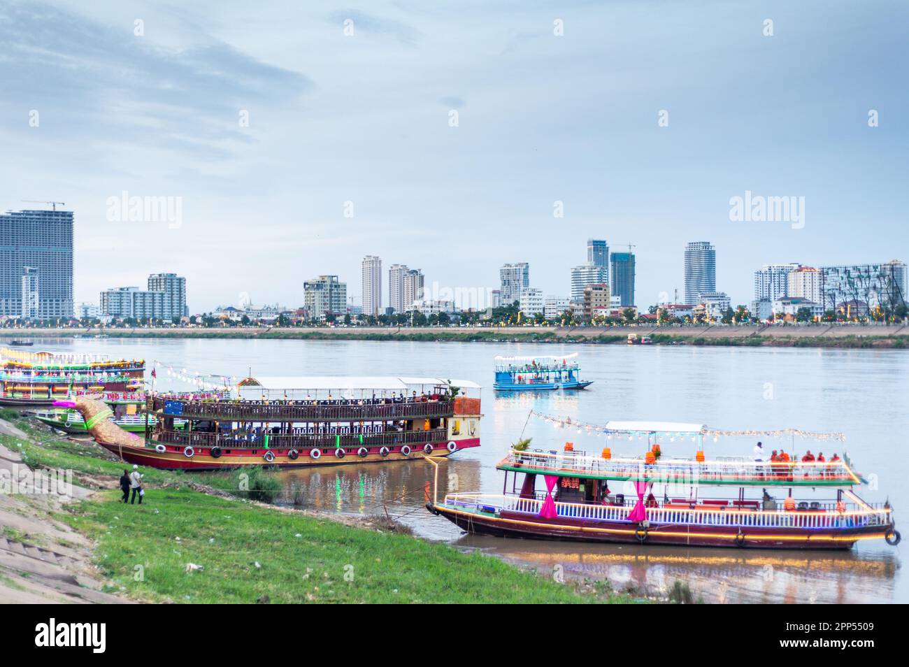 Illuminated with vibrant,colorful lights to attract tourists,the river craft,big and small,take trips up and down the Tonle Sap and Mekong rivers,visi Stock Photo