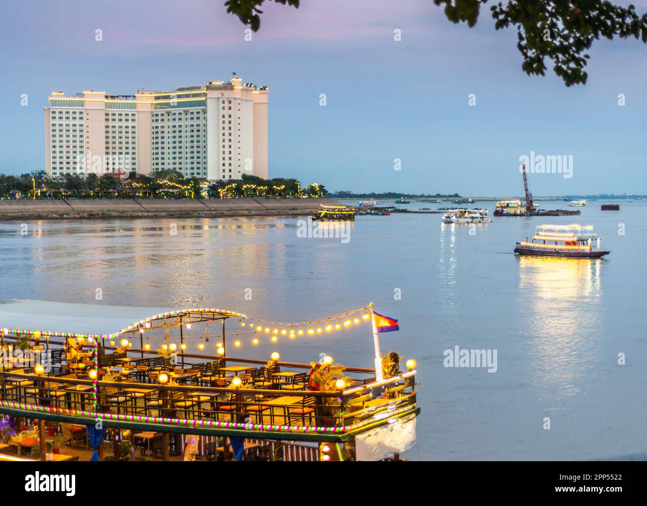 Illuminated with vibrant,strip lights to attract tourists,the river craft,big and small,take trips up and down the Tonle Sap and Mekong rivers,visitin Stock Photo