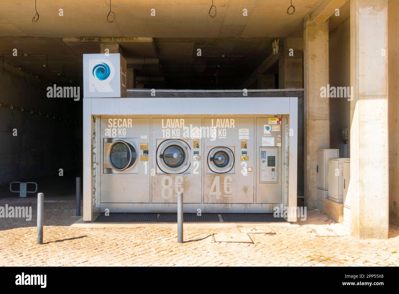 outdoor washing machines in launderette in albufeira marina algarve  portugal Stock Photo - Alamy
