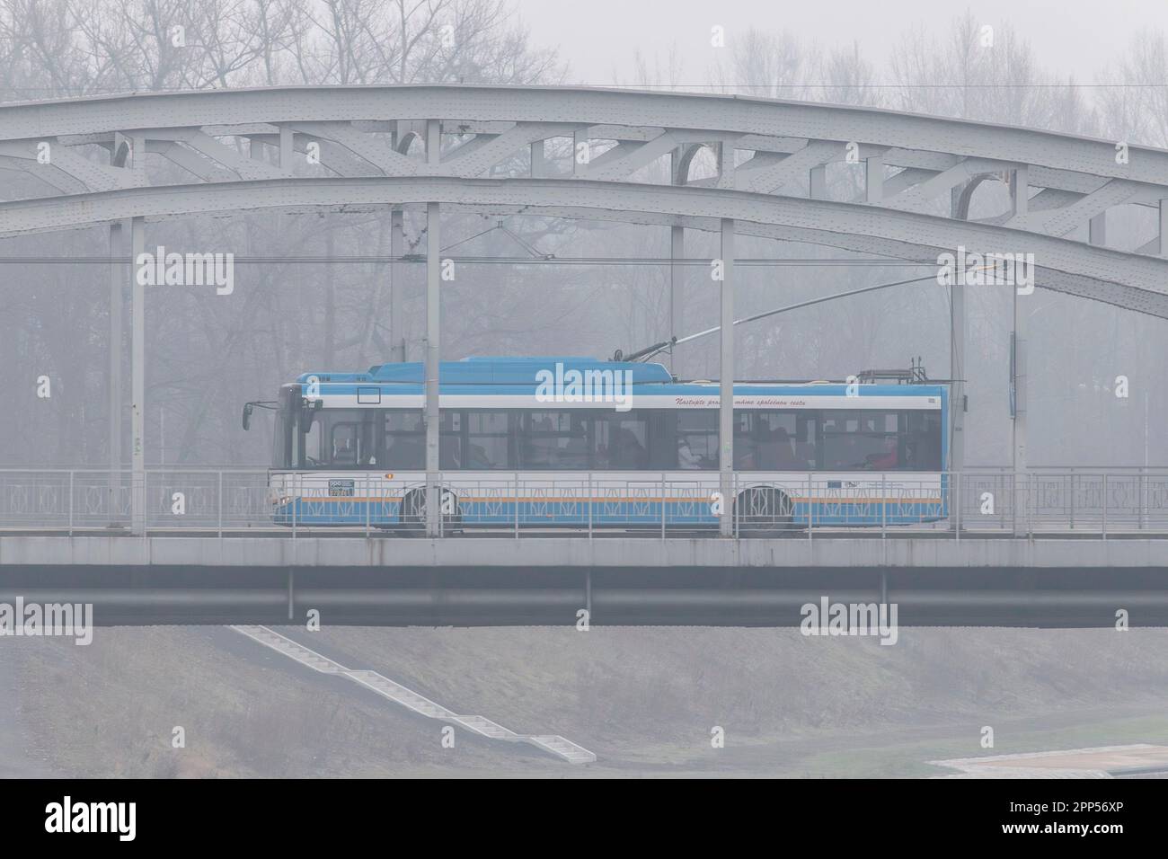 OSTRAVA, CZECH REPUBLIC - DECEMBER 12, 2014: Skoda 26Tr Solaris trolleybus of DPO transportation company in Ostrava in winter smog situation Stock Photo