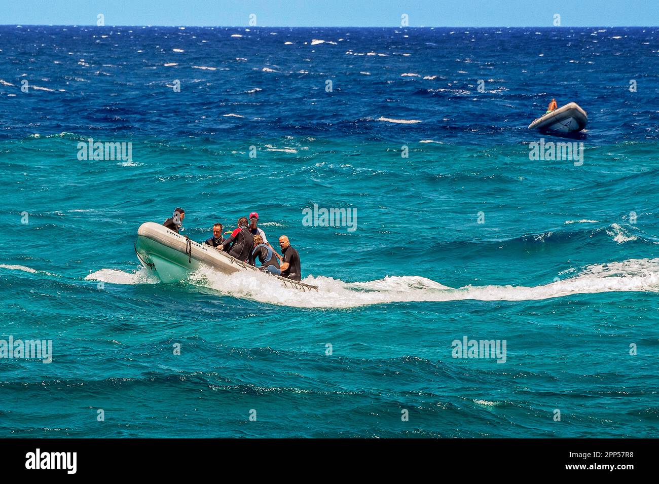 Rubber dinghies with divers in turquoise and blue water on Sanganeb
