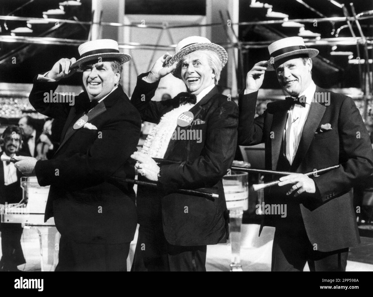 File photo dated 20/12/87 of (left to right) Labour MP for Leeds East, Denis Healey, Barry Humphries, who is dressed as Australian cultural attache Sir Les Patterson, and former James Bond star Roger Moore take part in a Vaudeville routine for LWT's The Dame Edna Christmas Experience. Comedian Barry Humphries, better known as his alter ego Dame Edna Everage, has died at the age of 89, according to a spokesperson for St Vincent’s Hospital in Sydney where he was being treated. Issue date: Saturday April 22, 2023. Stock Photo