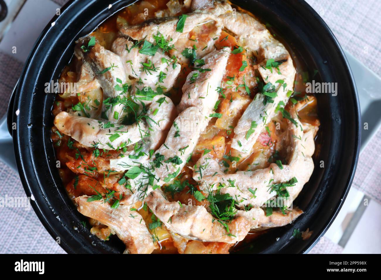 Fish with vegetables in tagine in restaurant Stock Photo Alamy