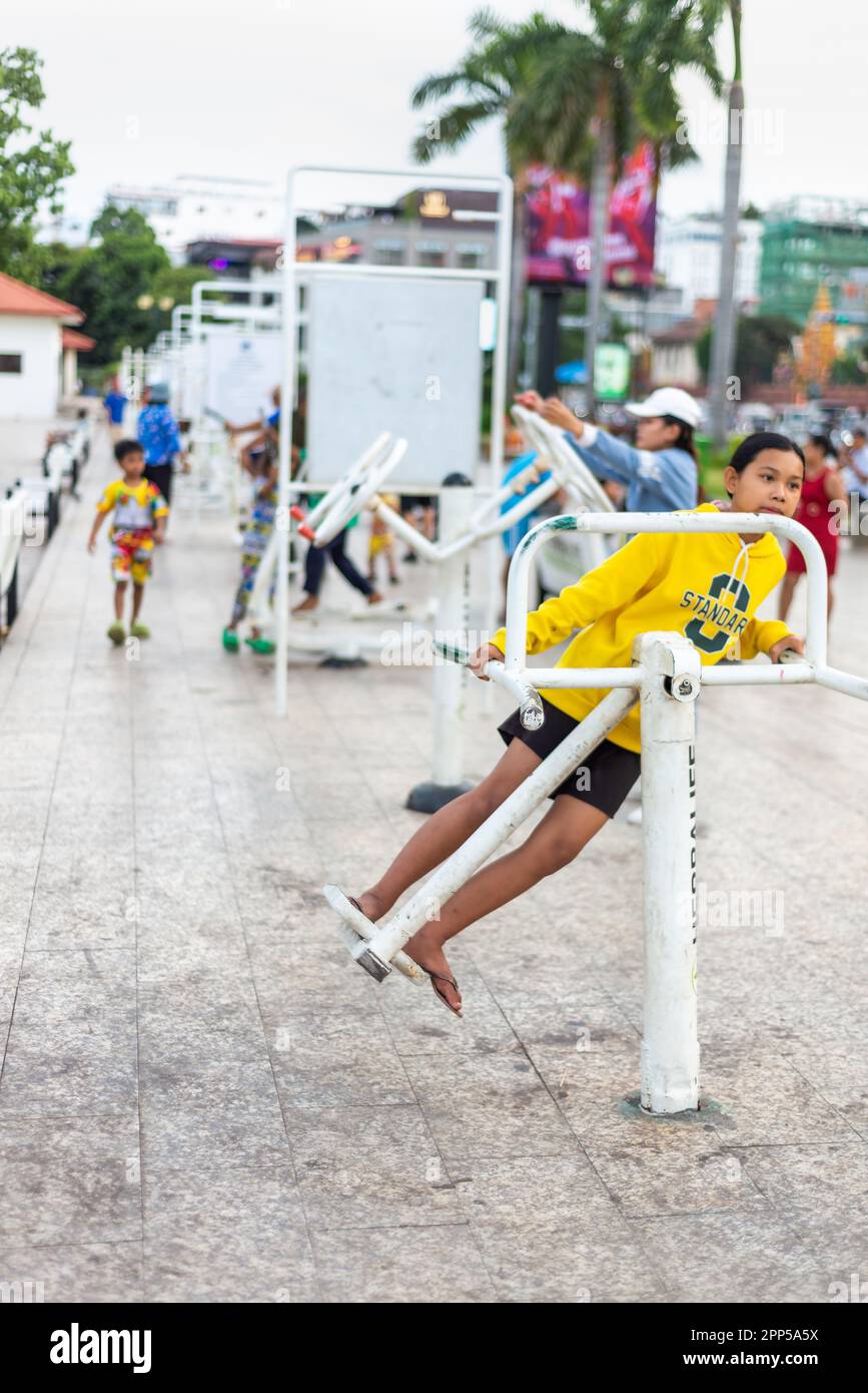 Phnom Penh,Cambodia-January 4th 2023: At sunset many citizens of Phnom Penh come to Sisowath Quay to use the fitness apparatus for physical health,enj Stock Photo