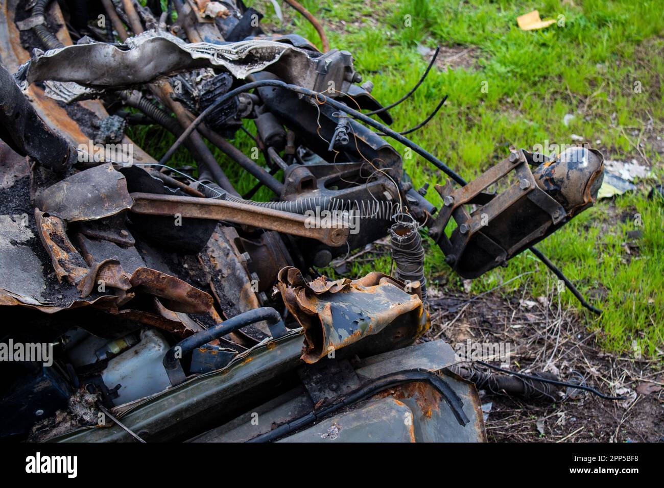 Aftermath of a mine explosion. The car is totally destroyed and debris is strewn all around. A large number of defensive and attack explosives are use Stock Photo