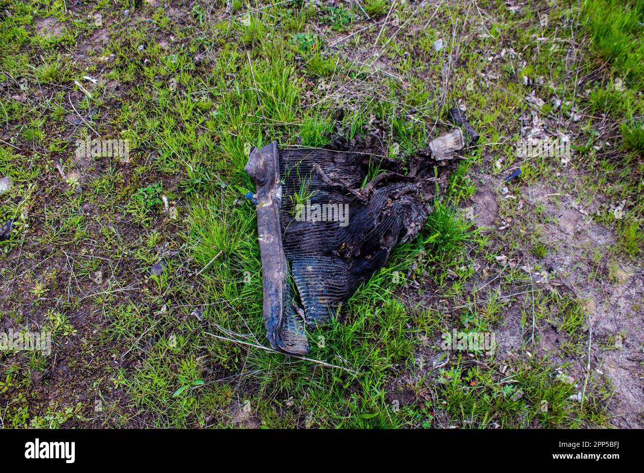 Aftermath of a mine explosion. The car is totally destroyed and debris