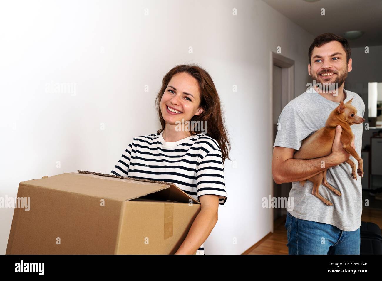 Young family with a dog moving to a new house Stock Photo Alamy